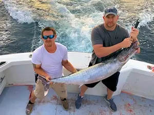 Young gentleman vacationing in Duck, NC with nice wahoo he caught on a charter trip.