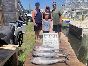 Family standing with their catch of tuna while vacationing in Kitty Hawk.