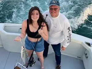 Father and cute daughter showing off her spanish mackerel during her Kitty Hawk trip.