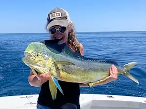 Excited lady angler with her fresh caught mahi.