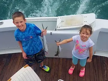 Two children anglers on a family friendly fishing charter.