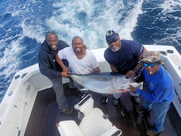 These angler all pitched in to help hold up this massive tuna that one of them just reeled in on Wild Card.