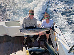 Two anglers holding up a really big tuna on another offshore charter trip on Wild Card Sportfishing.