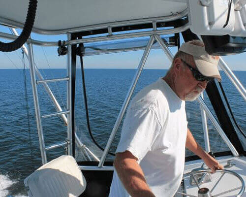 Capt. Frank Smith at the helm of Wild Card.
