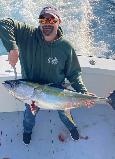Happy OBX angler holding nice yellowfin tuna.